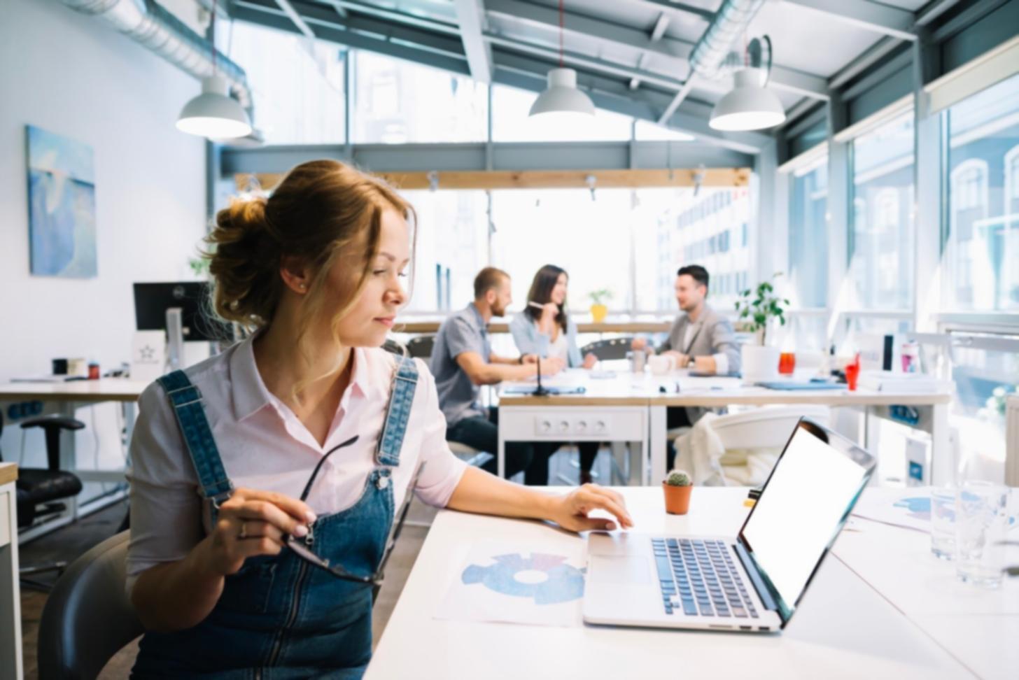 IT professionals collaborating around computer workstations during network troubleshooting session